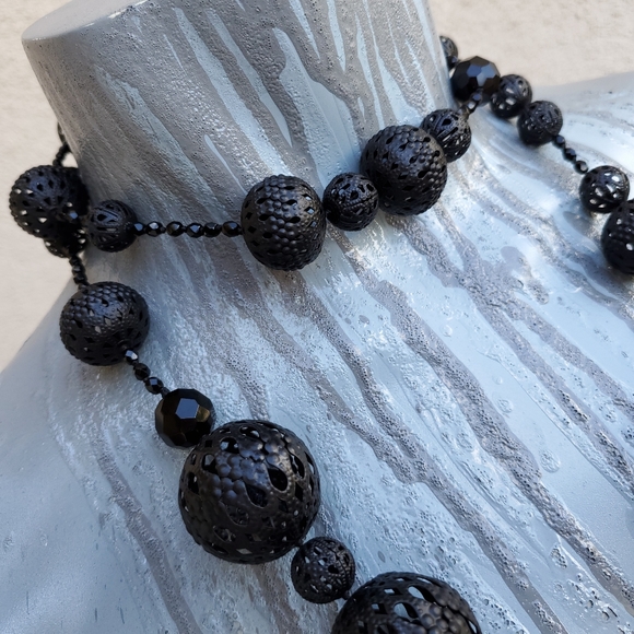 Black necklace with pierced metal beads